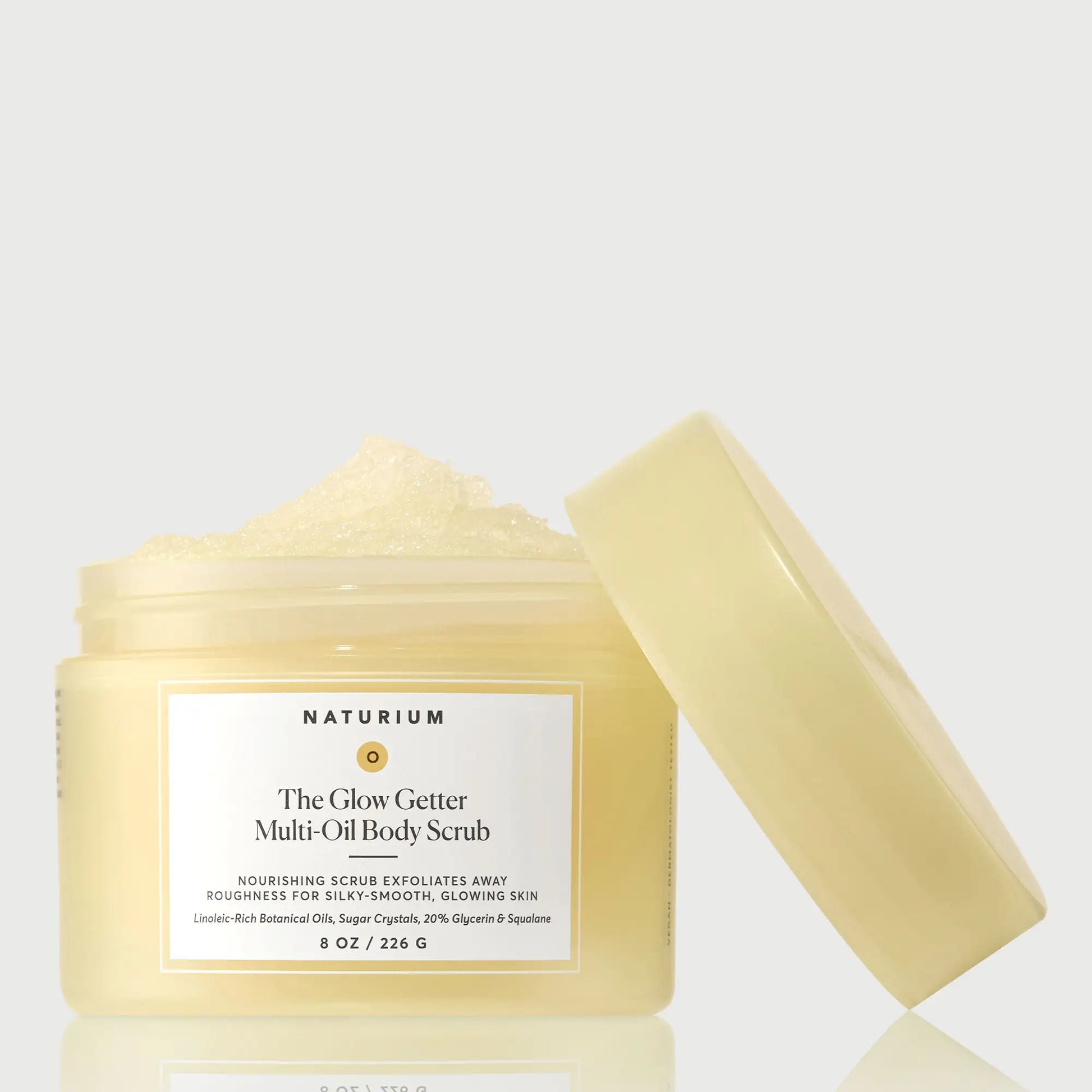 the-glow-getter-multi-oil-body-scrub-i1 NATR-40028-GlowGetter-Multi-Oil-Body-Scrub-Front-CapOff-bonebkgd.webp